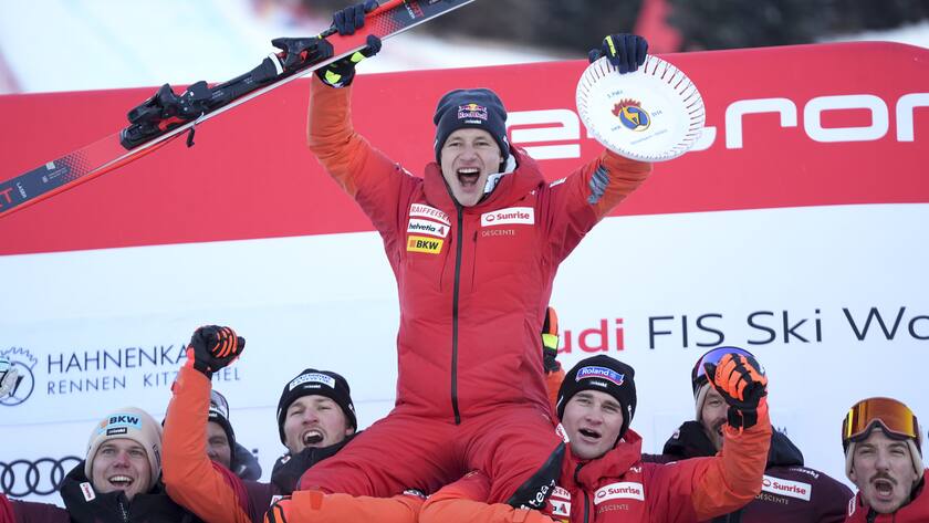 Switzerland's Marco Odermatt celebrates with the team after taking second place in an alpine ski, men's World Cup downhill race, in Kitzbuehel, Austria, Saturday, Jan. 20, 2024. (AP Photo/Giovanni Auletta)