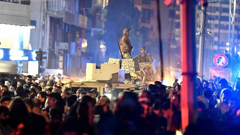 epa11054044 Lebanese soldiers stand atop an armoured vehicle at the site of an explosion in the southern district of Dahiyeh, Beirut, Lebanon, 02 January 2024. According to Lebanese state media, at least six people were killed in an explosion following an Israeli drone strike, including Hamas deputy head, Saleh al-Arouri. EPA/ABBAS SALMAN