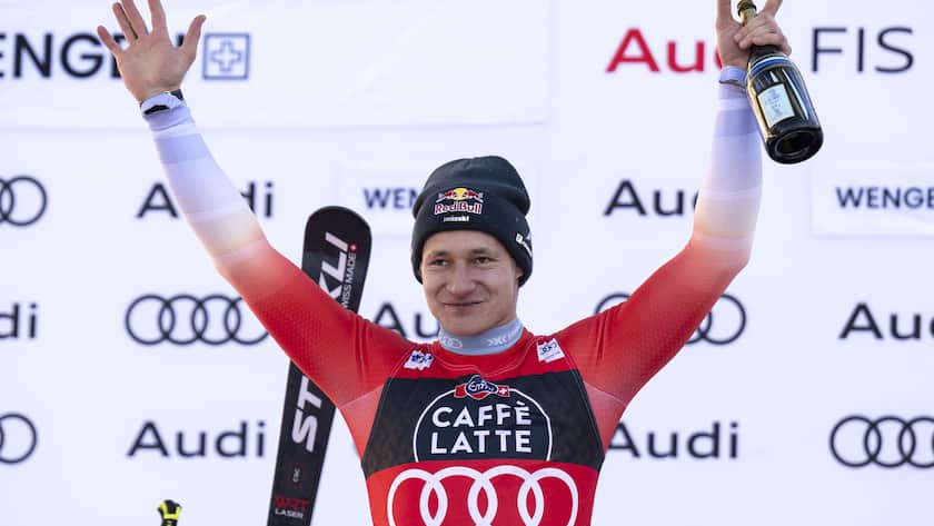 Marco Odermatt of Switzerland, winner, celebrates in the finish area during the flower ceremony after the men's downhill race at the Alpine Skiing FIS Ski World Cup in Wengen, Switzerland, Saturday, January 13, 2024. (KEYSTONE/Peter Schneider)