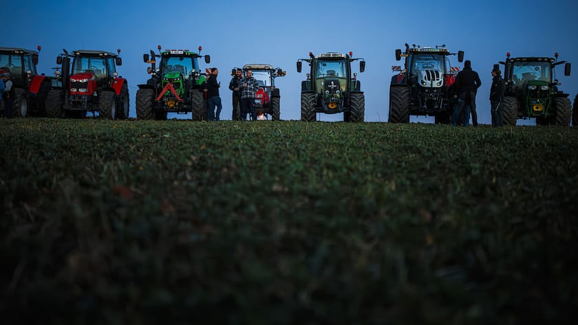 Farmers organize themselves to form a giant "SOS" distress signal with their tractors as coordinated stunt replicated in various locations across Switzerland, protesting against their work conditions and here specifically the price of milk, echoing numerous protests accross Europe in the recents weeks, in a field between the villages of Echallens and Goumoens-la-Ville, Switzerland, Thursday, February 29, 2024. (KEYSTONE/Valentin Flauraud)