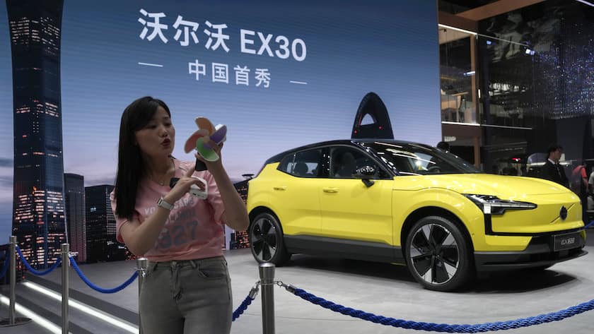 A live streamer works near the Volvo EX30 fully electric small SUV unveiled during Auto China 2024 in Beijing, Thursday, April 25, 2024. Global automakers and EV startups unveiled new models and concept cars at China's largest auto show on Thursday, with a focus on the nation's transformation into a major market and production base for digitally connected, new-energy vehicles. (AP Photo/Ng Han Guan)