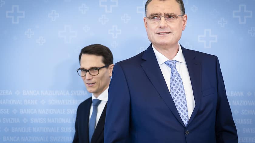 Swiss National Bank's (SNB) Chairman of the Governing Board Thomas Jordan, right, arrives with Vice Chairman of the Governing Board Martin Schlegel, left, to a media briefing at the Swiss National Bank in Zurich, Switzerland, on Thursday, March 21, 2024. (KEYSTONE/Michael Buholzer).