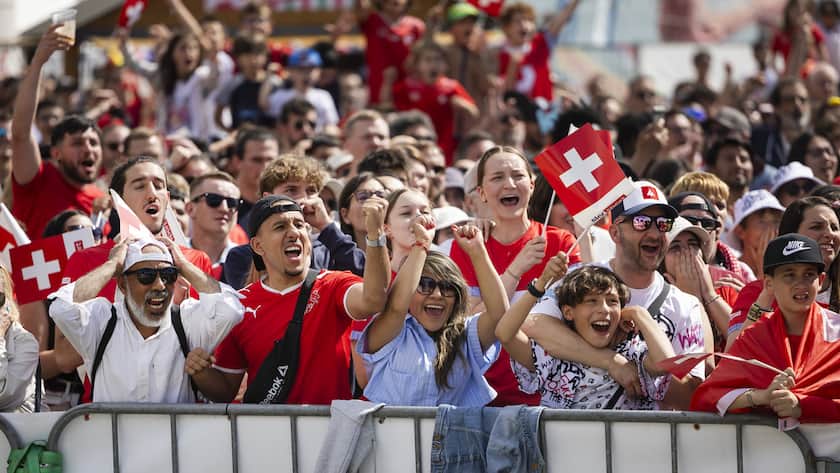 Swiss soccer fans react during the live broadcast of the UEFA EURO 2024 soccer match between Hungary and Switzerland in a fan zone in Lausanne, Switzerland, Saturday, 15. June 2024.(KEYSTONE/Cyril Zingaro)