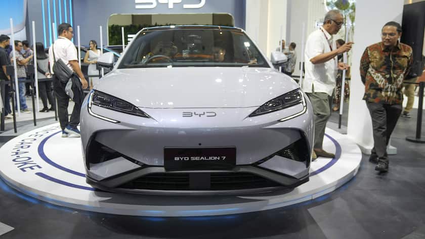 Visitors examine a BYD booth during the Indonesian International Motor Show in Jakarta, Indonesia, Thursday, Feb. 13, 2025.(AP Photo/Tatan Syuflana)