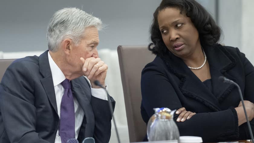 FILE - Federal Reserve Chairman Jerome Powell, left, talks with Board of Governors member Lisa Cook, right, during an open meeting of the Board of Governors at the Federal Reserve, June 25, 2025, in Washington. (AP Photo/Mark Schiefelbein, File)