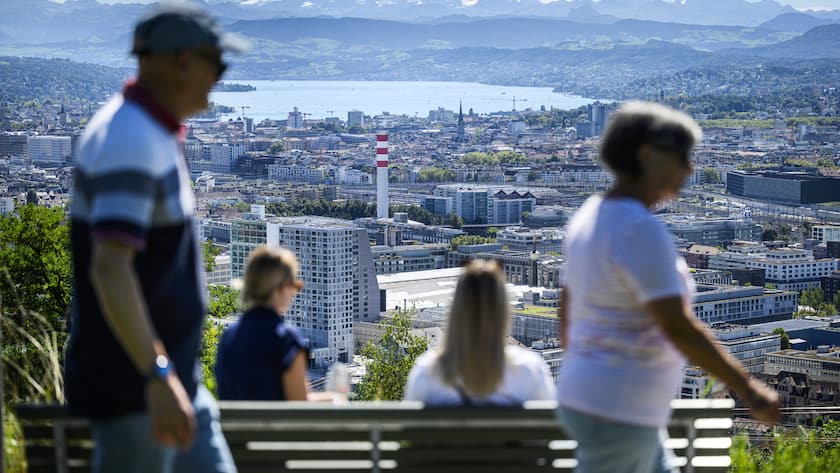 Leute geniessen die Aussicht auf den Zuerichsee und die Stadt bei bestem Wetter, fotografiert am Sonntag, 29. August 2025 von der Waid in Zuerich. (KEYSTONE/Christian Beutler)