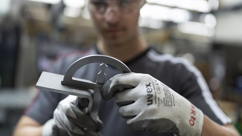 Unsere Industrie ist dem Zollhammer gewachsen Ein Mitarbeiter von Schindler biegt mit der hydraulischen Biegemaschine und misst den Winkel eines Teils eines Schindler Lifts, fotografiert am Donnerstag, 17. Juli 2025 im Hauptsitz von Schindler in Ebikon. (KEYSTONE/Gaetan Bally)