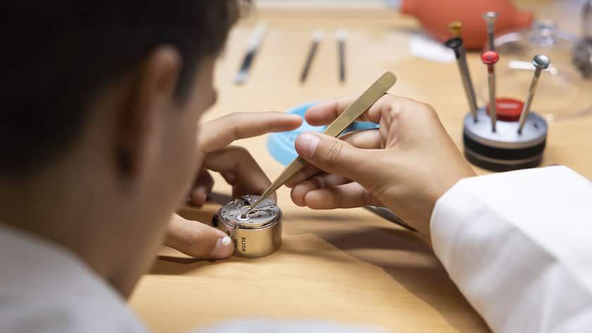 Ein junger Mann uebt bei einem Stand der Uhrmacher mit einer Pinzette und einem Uhrwerk, bei den Schweizer Berufsmeisterschaften SwissSkills 2022, am Freitag, 9. September 2022, in Bern. (KEYSTONE/Peter Klaunzer)