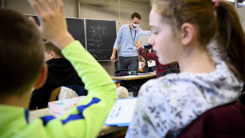 Teacher Matthieu Macchi wears a transparent protective face mask as he teache to pupils including one child with hearing loss at a primary school during the coronavirus disease (COVID-19) outbreak, in Lausanne, Switzerland, Thursday, December 17, 2020