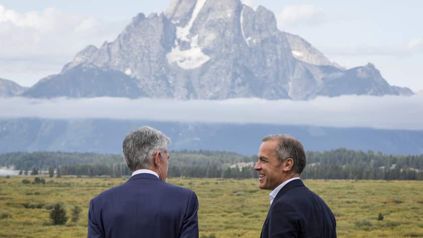 Federal Reserve Chairman Jerome Powell, left, and Bank of England Governor Mark Carney, right, walk together after Powell's speech at the Jackson Hole Economic Policy Symposium on Friday, Aug. 23, 2019, in Jackson Hole, Wyo. (AP Photo/Amber Baesler)