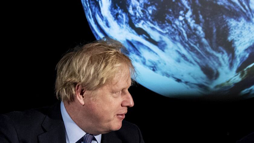 Britain's Prime Minister Boris Johnson launches the upcoming UK-hosted COP26 UN Climate Summit that will take place in autumn 2021 in Glasgow, Scotland, during an announcement in London Tuesday Feb. 4, 2020. Johnson is expected to announce a target to stop selling new petrol and diesel vehicles by 2035, including hybrid vehicles for the first time. (Chris J Ratcliffe/Pool via AP)