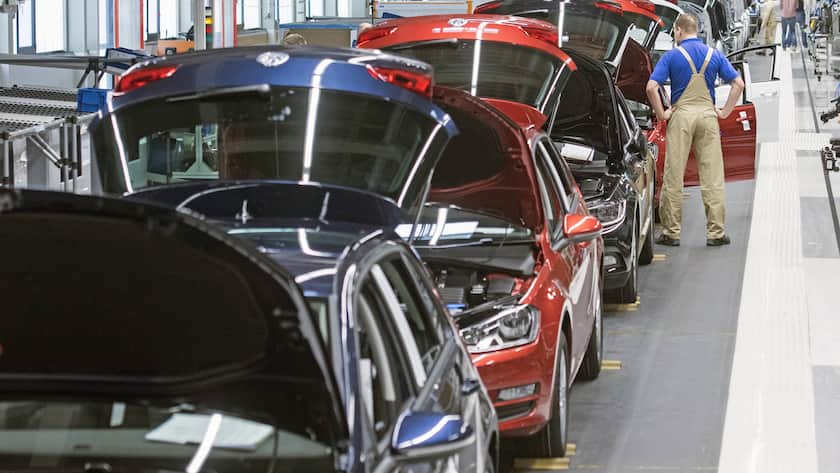 Workers assembles cars during a press tour at the plant of the German manufacturer Volkswagen Sachsen in Zwickau, Germany, Monday, Jan. 26, 2015. More than 4.7 Million Golf and Passat vehicles have left the production facilities since foundation of the Zwickau plant in 1990. (AP Photo/Jens Meyer)
