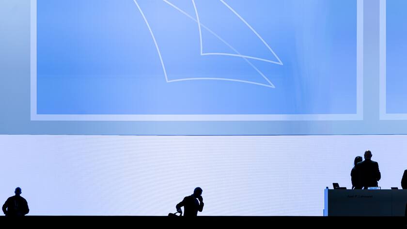 Swiss bank Credit Suisse Chairman Axel P. Lehmann, center, leaves the stage after theannual shareholders' meeting of the Swiss banking group on Tuesday, April 4, 2023 in Zurich, Switzerland. Swiss Bank Credit Suisse was rescued in a three billion dollars purchase by its Swiss rival UBS in a government-backed deal. (KEYSTONE/Michael Buholzer)