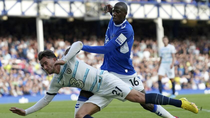 Chelsea's Ben Chilwell, front, duels for the ball with Everton's Abdoulaye Doucoure during the English Premier League soccer match between Everton and Chelsea at Goodison Park in Liverpool, England, Saturday, Aug. 6, 2022. (AP Photo/Jon Super)