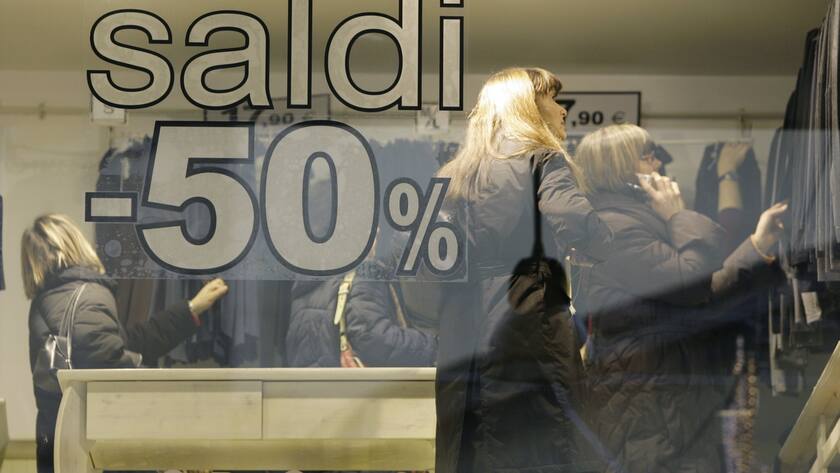 Woman look for clothes inside a shop during the first day of sales in downton Milan, Italy, Saturday, Jan. 5, 2008. (AP Photo/Luca Bruno)