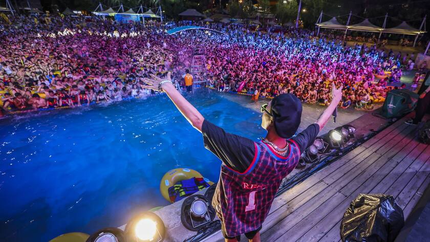 epa08615868 People enjoy a music party inside a swimming pool at the Wuhan Maya Beach Park in Wuhan, Hubei province, China, 15 August 2020 (issued 21 August 2020). Huge crowds gathered for the pool party in Wuhan, the epicenter of the COVID-19 pandemic in China. According to Chinese authorities, the photos and videos of the party that sparked worldwide outrage, show how effectively the country has recovered from the pandemic. EPA/STR CHINA OUT