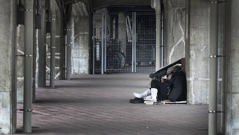A homeless rests under a pedestrian bridge in Yokohama, Monday, Nov. 17, 2014. In a surprise, Japan said its economy, the world's third-biggest following the U.S. and China, contracted 1.6 percent at an annual pace in the July-September quarter as consumer and corporate spending failed to regain momentum after a sales tax increase in April. (AP Photo/Eugene Hoshiko)
