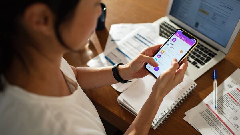Woman managing finances through mobile banking at home
