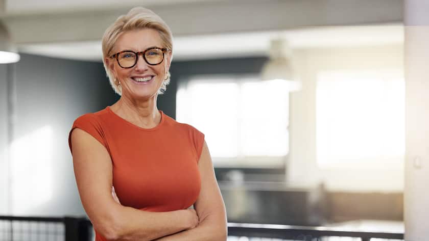 Portrait, arms crossed and smile of business woman in office with pride for career and job. Ceo glasses, boss face and happy, confident and proud elderly female entrepreneur from Canada in company.