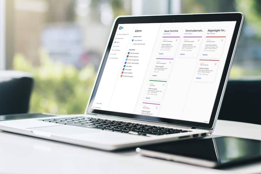 Close up of modern laptop with blank screen on white table in sunny interior, mockup. Business and technology concept