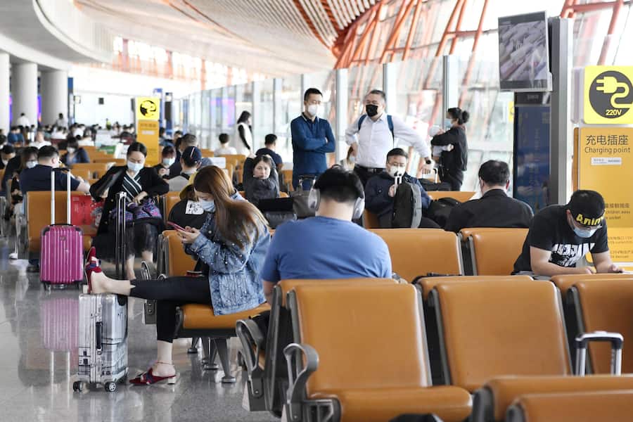 People wait at a boarding area for domestic flights at Beijing Capital International Airport on May 10, 2020. The Civil Aviation Administration of China said May 13 that the number of passengers carried by Chinese airlines in April plunged 68.5 percent from a year earlier amid the coronavirus pandemic. (Photo by Kyodo News via Getty Images)
