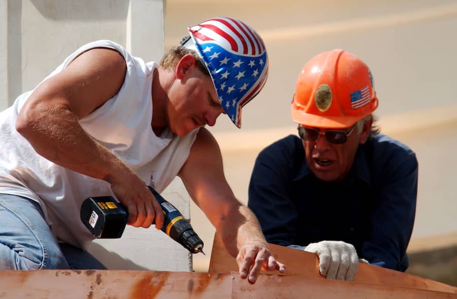 402159 09: A construction worker wears a patriotic hardhat while working on decorative metal work March 12, 2002 located at the Grove shopping center in Los Angeles, CA. Federal Reserve Chairman Alan Greenspan announced last week that an economic expansion was already "well under way,'''' in effect, declaring that the U.S. economic downturn was over. The mall is scheduled to open March 16, 2002 to the public. (Photo by David McNew/Getty Images)