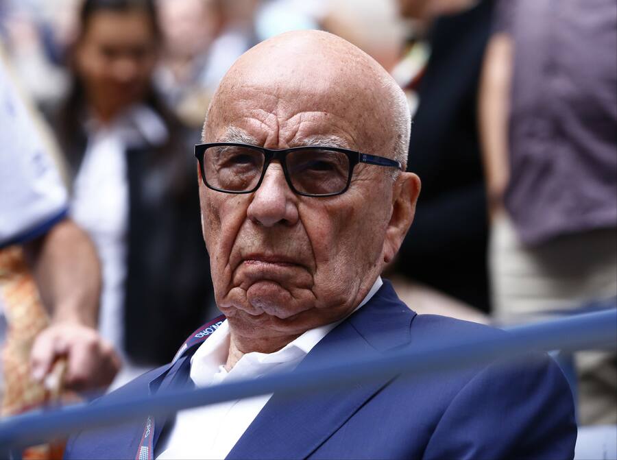 FILE- In this Sunday, Sept. 10, 2017 file photo, Rupert Murdoch waits for the start of the men's singles final of the U.S. Open tennis tournament in New York. Rupert Murdoch's British newspaper company has agreed to pay damages to a former intelligence officer whose computer was hacked by detectives working for Murdoch's now-defunct News of the World tabloid, lawyers said Friday, Oct. 6, 2017. (AP Photo/Julio Cortez, File)