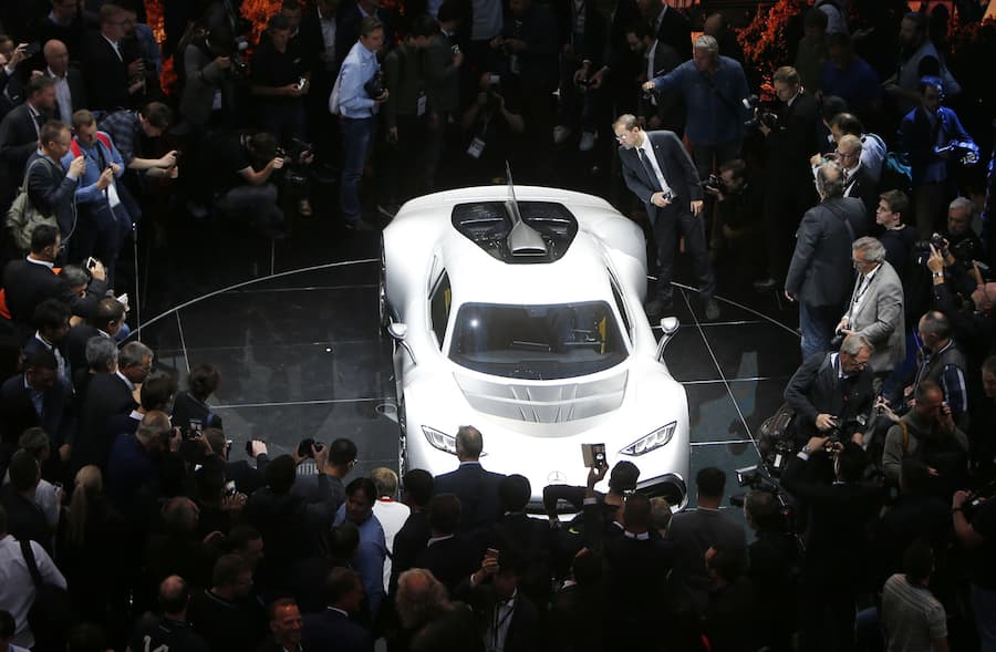 Visitors surround the Mercedes-AMG Project One hyper car during the first media day of the International Frankfurt Motor Show IAA in Frankfurt, Germany, Tuesday, Sept. 12, 2017, which runs through Sept. 24, 2017. (AP Photo/Michael Probst)