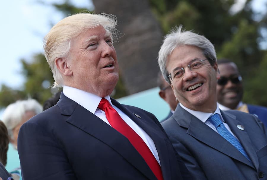 TAORMINA, ITALY - MAY 27: U.S. President Donald Trump (L) and Italian Prime Minister Paolo Gentiloni chat during the group photo for the G7 Outreach Program on the second and last day of the G7 Taormina summit on the island of Sicily on May 27, 2017 in Taormina, Italy. Leaders of the G7 group of nations, which includes the Unted States, Canada, Japan, the United Kingdom, Germany, France and Italy, as well as the European Union, are meeting at Taormina from May 26-27. (Photo by Sean Gallup/Getty Images)