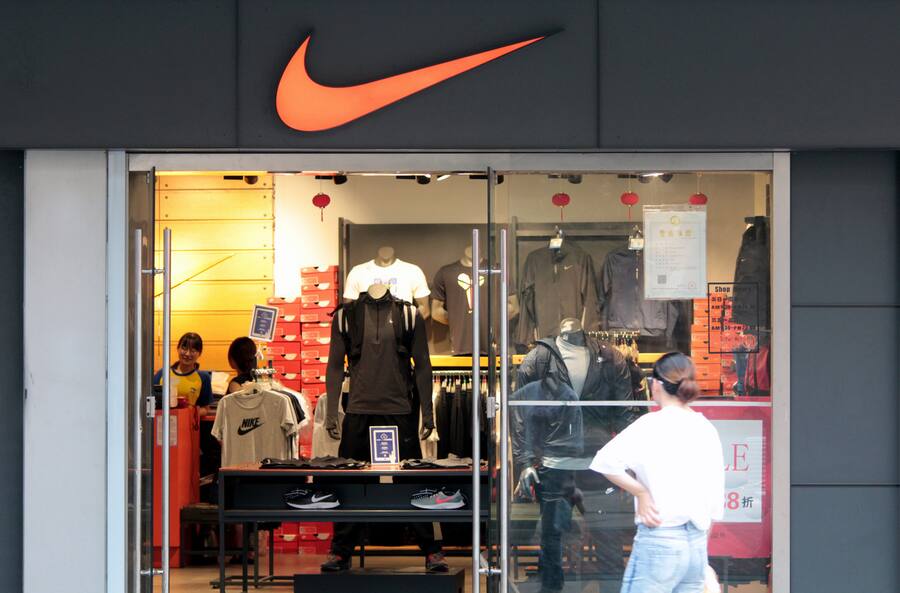 --FILE--A pedestrian walks past a Nike store in Shanghai,
