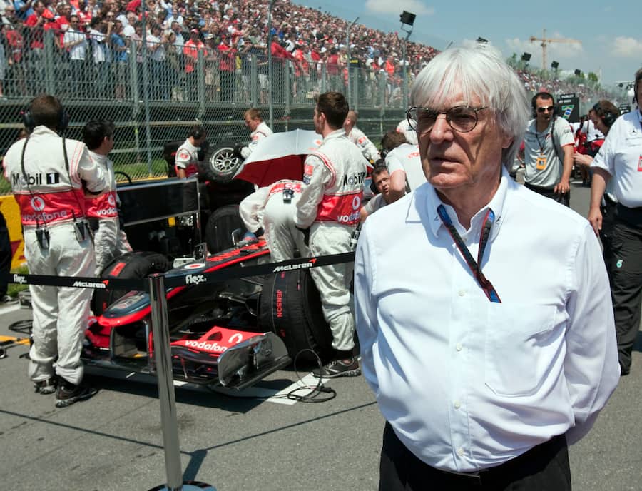 Formula one boss Bernie Ecclestone walks through the starting grid before the Canadian Grand Prix auto race Sunday, June 13, 2010, in Montreal. (AP Photo/The Canadian Press,Paul Chiasson)