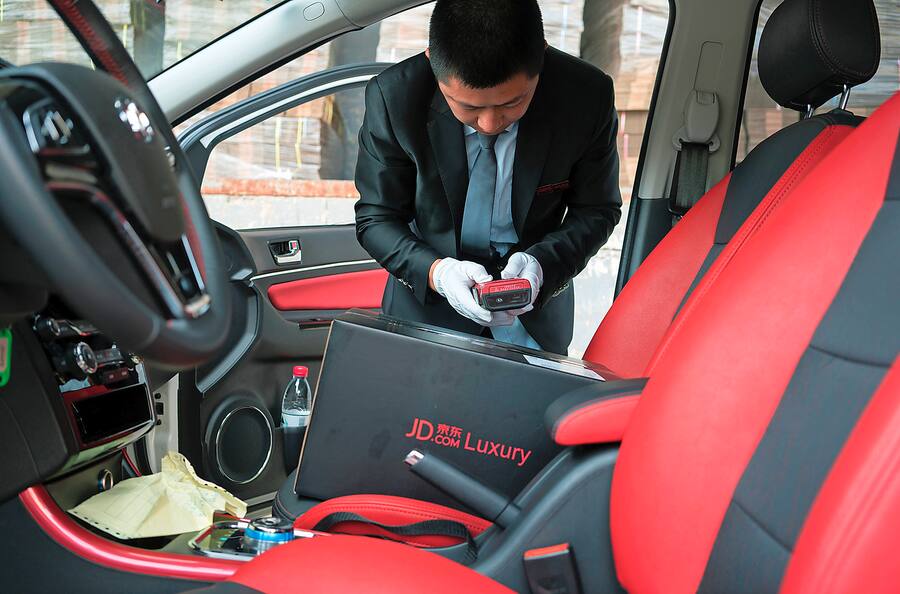 Tang Hongliang, a driver for the JD.com luxury service, gets ready to start the workday in Beijing, June 29, 2017. To court the luxury market, companies like JD.com are using their customer base to offer upscale retailers support on things like white glove deliveries. (Giulia Marchi/The New York Times)