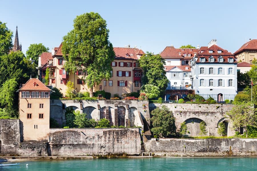 Beautiful view of Basel waterfront with stone fortification and medieval houses at sunny day, Switzerland
