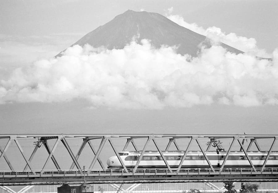 FILE - In this Oct. 1982 file, Japan's Shinkansen, high speed train, travels past Mount Fuji, crossing over the Fuji River, west of Tokyo. Zipping cross-country in a super-high speed train has become commonplace in many countries these days, but it was unheard of when Japan launched its bullet train between Tokyo and Osaka 50 years ago Wednesday, Oct. 1, 2014. (AP Photo/Fie)