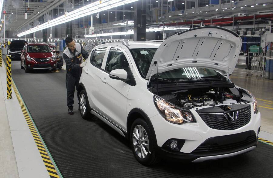 Workers examine vehicles at a VinFast plant on June 14, 2019, in Hai Phong, Vietnam. VinFast is a subsidiary of Vietnamese conglomerate Vingroup. The plant was inaugurated the same day, and will soon begin commercial production of the first full-fledged Vietnamese-made cars. (Kyodo)==Kyodo(Photo by Kyodo News Stills via Getty Images)