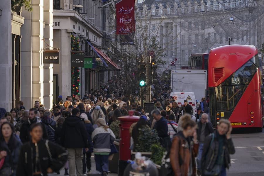 Shoppers walk in Regent Street, in London, during Black Friday sales, Nov. 25, 2022.(AP Photo/Alberto Pezzali)