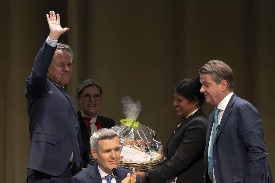 Colm Kelleher, Chairman of the Board of Directors of Swiss Bank UBS, and Lukas Gaehwiler, Vice Chairman of the Board of Directors, say goodbye to Ralph Hamers, Chief Executive Officer, from right, during the general assembly of the UBS in Basel, Switzerland, on Wednesday, April 5, 2023. (KEYSTONE/Georgios Kefalas)
