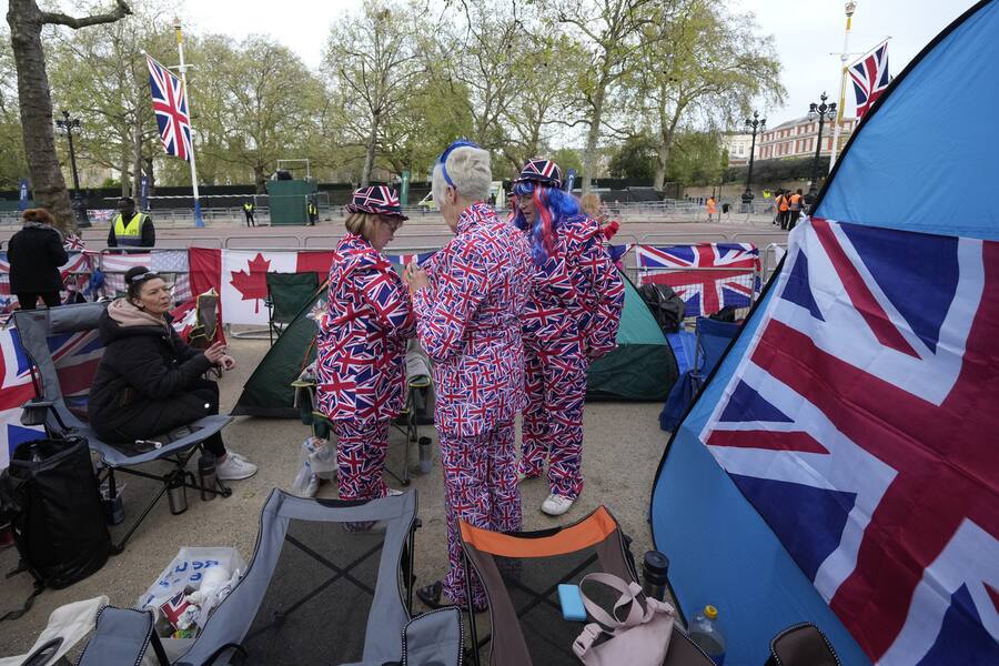 Royal fans who have spent the night camping out along the Mall, part of the Coronation route, wake up and leave their tents in London, Friday, May 5, 2023. King Charles III will be crowned king on Saturday,May, 6, in Westminster Abbey .(AP Photo/Alessandra Tarantino)
