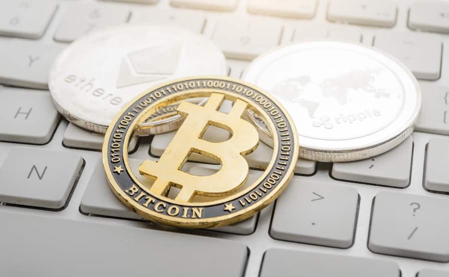 cryptocurrency coins - Etherum, Bitcoin, Ripple on the keyboard