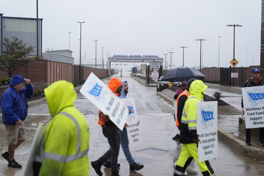 Dockworkers strike at the entrance to a container terminal at the Port of Baltimore, Tuesday, Oct. 1, 2024, in Baltimore. (AP Photo/Stephanie Scarbrough)