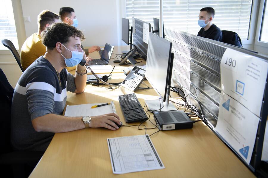 Un traceur parle au telephone apres une conference de presse Covid-19 et la strategie TTIQ (tests, tracage, isolement, quarantaine) ainsi que les nouveautes dans le canton de Vaud lors de la 2eme vague de la pandemie de Coronavirus (Covid-19) ce lundi 7 decembre 2020 au Centre de tracage a Lausanne. (KEYSTONE/Laurent Gillieron)