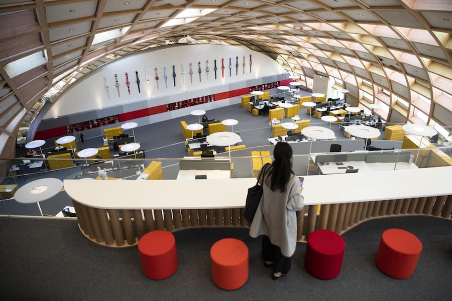 A visitor walks through the offices of the new head office building of the Swatch Group, Thursday, October 3, 2019, in Biel, Switzerland. (KEYSTONE/Peter Klaunzer)