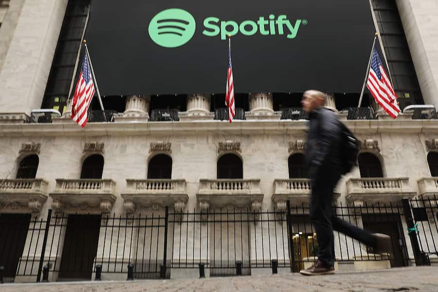 NEW YORK, NY - APRIL 03: People walk by the New York Stock Exchange (NYSE) on the morning that the music streaming service Spotify begins trading shares at the NYSE on April 3, 2018 in New York City. Trading under the symbol SPOT, the Swedish company's losses grew to 1.235 billion euros ($1.507 billion) last year, its largest ever. (Photo by Spencer Platt/Getty Images)